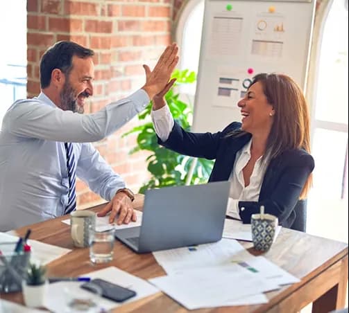 Two colleagues celebrating a successful pilot